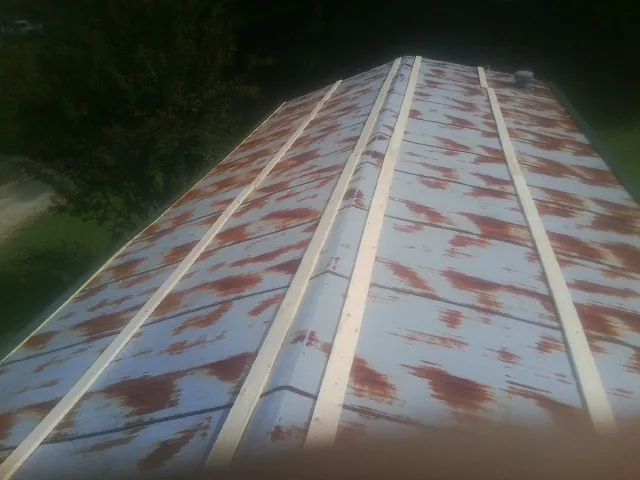 Rusted metal roof panels with new wood purlins before replacement — Storm Damage Roof Repair in Bixby by Roofing Brothers
